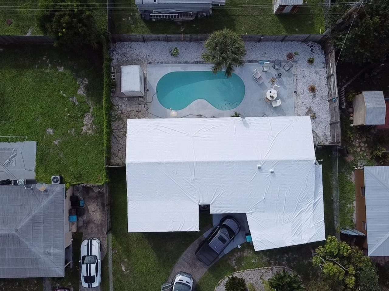 Wrapped roof beside a kidney-shaped pool, seen from directly above